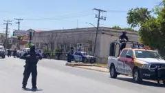 State police officers stand guard near a crime scene in Matamoros, Mexico