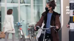 Daily life in Eindhoven city in the Netherlands with people wearing facemask as they are outside