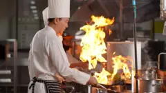 Chef team preparing food in the kitchen of a hotel restaurant