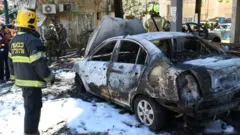 Police and rescue teams at the scene of a direct rocket hit in Ramat Gan, Israel, May 15, 2021