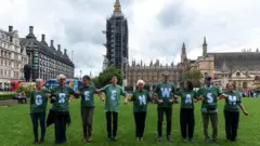 Protesters in London former the word greenwash during a march in 2021