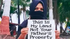 A woman protesting in Lakshadweep