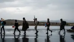 Tigray People's Liberation Front (TPLF) fighters walk in lines towards another field in Mekele, the capital of Tigray region, Ethiopia, on June 30, 2021.