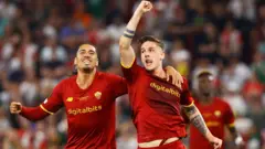 AS Roma's Nicolo Zaniolo celebrates scoring their first goal with Chris Smalling