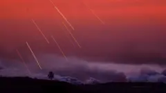 Israeli shells strike the northern part of the Gaza Strip during sunset, 29 October 2023.