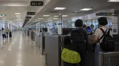 Two people have their passports checked at a US international airport