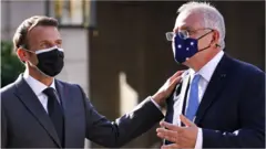 French President Emmanuel Macron claps the shoulder of Australia Prime Minister Scott Morrison at a meeting in Paris in June 2021
