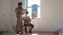 Мужчина стрижет ребенка