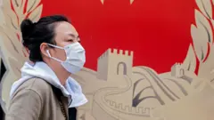 A woman wearing a facemask in Beijing, China