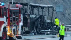 Officials work at the site of a bus accident, in which at least 45 people were killed after the vehicle caught fire, on a highway near the village of Bosnek, south of Sofia, on November 23, 2021