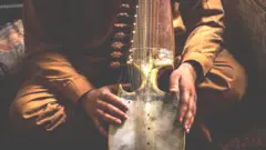 afghan person holding instrument