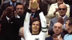 Franz Beckenbauer holds the World Cup trophy