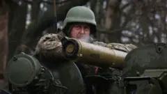 Mwanajeshi wa Ukraine akiwa amesimama karibu na mstari wa mbele