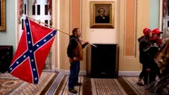Man seen carrying a Confederate flag in the US Capitol