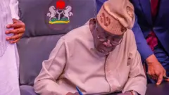 Tinubu on cap wit pen