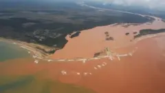 Rio cheio de lama desaguando no oceano