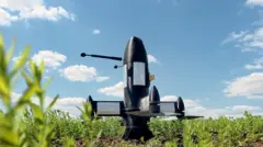 A P1-SUN Ukrainian interceptor drone sits in a green field under a blue sky. It's a black, bullet-shaped drone with four propellers at its base