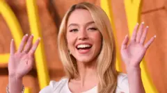 Sydney Sweeney waving