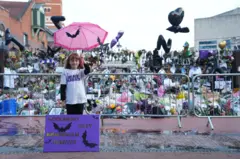 Eliza Finn-O'shea, de 10 años, posa junto a un cartel con murciélagos en el que recuerda a Ozzy Osbourne