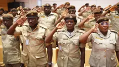Immigration officers dressed in dia uniform as dem dey salute