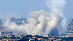 Smoke billows from the site of an Israeli air strike that targeted southern Lebanese villages, as seen from Marjaayoun, southern Lebanon, on 25 September 2024