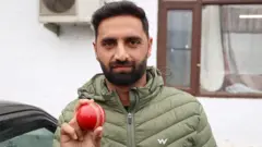 Auqib Nabi Dar poses with a red cricket ball in Baramulla, Jammu and Kashmir, India, on March 18, 2026. Auqib Nabi Dar is an Indian cricketer who plays as a right-arm medium bowler. He represents Jammu & Kashmir in domestic cricket and Delhi Capitals in the Indian Premier League. (Photo by Nasir Kachroo/NurPhoto via Getty Images)