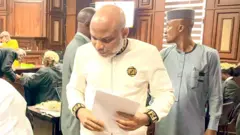 Nnamdi Kanu for court hold paper for hand