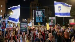 Demonstrators carry flags and placards as families of hostages and their supporters protest ahead of the two-year anniversary of the deadly October 7, 2023, attack on Israel by Hamas, demanding the immediate release of all hostages and the end of the war in Gaza, in Jerusalem, October 4, 2025. 