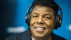 Late Tito Jackson smiling wit headphone for im ear