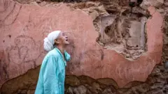 Mulher chora após terremoto na cidade velha de Marrakesh