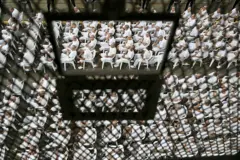 Presos en el Cecot, El Salvador, sentados en filas detrás de rejas durante una audiencia judicial remota en abril de 2026.
