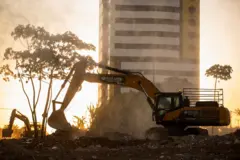 Escavadeira trabalhando em terreno durante o dia