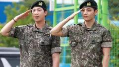 RM and V of BTS, dressed in military uniform, attend a discharge ceremony held at the soccer field of Sinbuk-eup Sports Park in Chuncheon-si on 10 June 10 in Chuncheon, South Korea