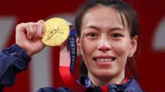 Tokyo 2020 Olympics - Weightlifting - Women"s 59kg - Medal Ceremony - Tokyo International Forum, Tokyo, Japan - July 27, 2021. Gold medalist Kuo Hsing-Chun of Taiwan reacts.