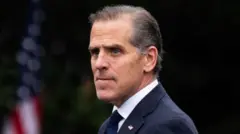 An image of Hunter Biden wearing a suit looking to his left 