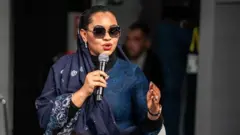 Natasha Akpoti speaking with a mic