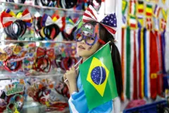 A girl displays football fans' headwear at the Yiwu International Trade Market on 19th April,2026 in Yiwu, Zhejiang province, China