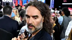 British actor Russell Brand pictured wear one dark suit