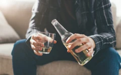รูปชายถือขวดและแก้วเหล้า 