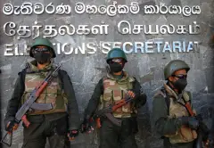 Army soldiers stand guard as anti-government protesters take part in a demonstration urging the government to hold the local council elections on the scheduled date in front of the Election Secretariat in Colombo on February 22, 2023