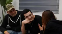 Edan Alexander, who was held hostage by Hamas, smiles after being reunited with his parents