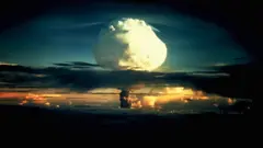 Un énorme champignon blanc, tacheté d'orange, traverse une couche de nuages pendant l'opération Ivy, le premier essai de la bombe à hydrogène, sur l'atoll d'Enewetak, dans les îles Marshall.