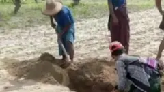 Two people digging