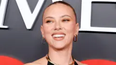 Scarlett Johansson smiling on a red carpet