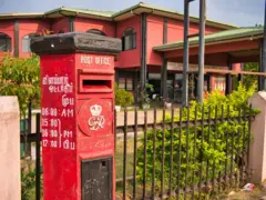 A colonial British red post box from the reign of George 6th (1936 - 1952) outside the Post Office at 249 Jaffna-Kankesanturai Rd, Jaffna, Sri Lanka.