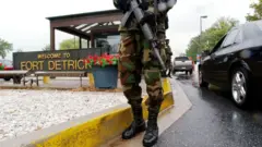 Military Personnel stand guard outside the US Army Medical Research Institute of Infectious Diseases at Fort Detrick