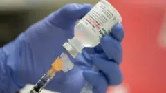 A mock vial of the Pfizer vaccine for the coronavirus disease (COVID-19) is shown during a staff vaccine training session at UW Health in Madison, Wisconsin, U.S., December 8, 2020.