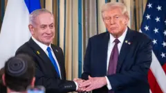 US President Donald Trump shakes hands with Israeli Prime Minister Benjamin Netanyahu after they spoke at a press conference in the White House in Washington, DC, on 29 September 2025.