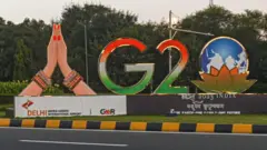 Traffic moves past a model of the G20 logo ahead of the G20 Summit in New Delhi, India on September 5, 2023. India will host the 18th G20 Summit from September 9-10 in New Delhi. (Photo by Kabir Jhangiani/NurPhoto via Getty Images)