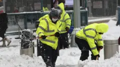 Workers shovel snow in Columbus Circle in New York